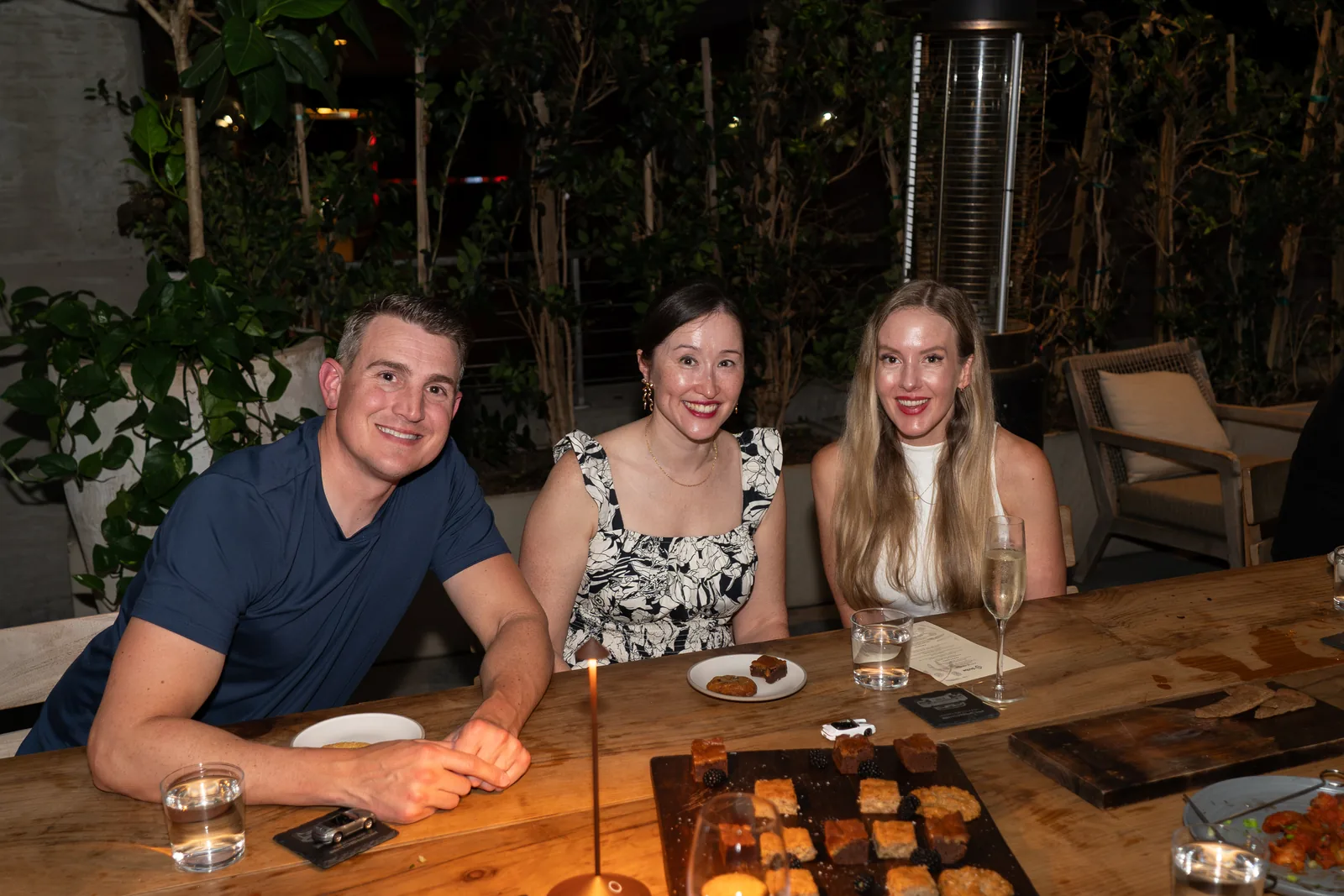 Three IGNITE 2026 guests at the candlelit dinner table Three IGNITE 2026 guests at the candlelit dinner table