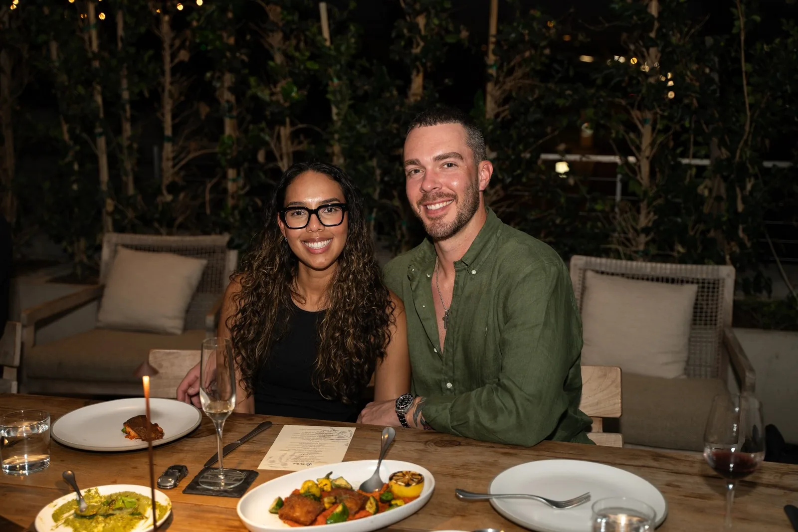 Two IGNITE 2026 guests smiling at the dinner table