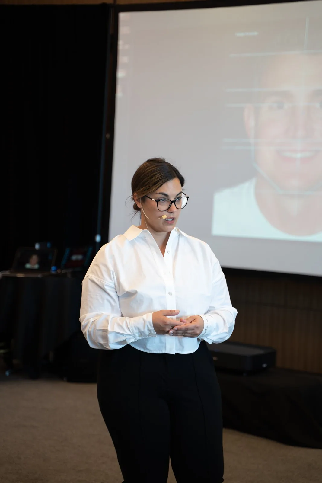 Dr. Andi-Jean Miro presenting a smile case on screen at IGNITE 2026