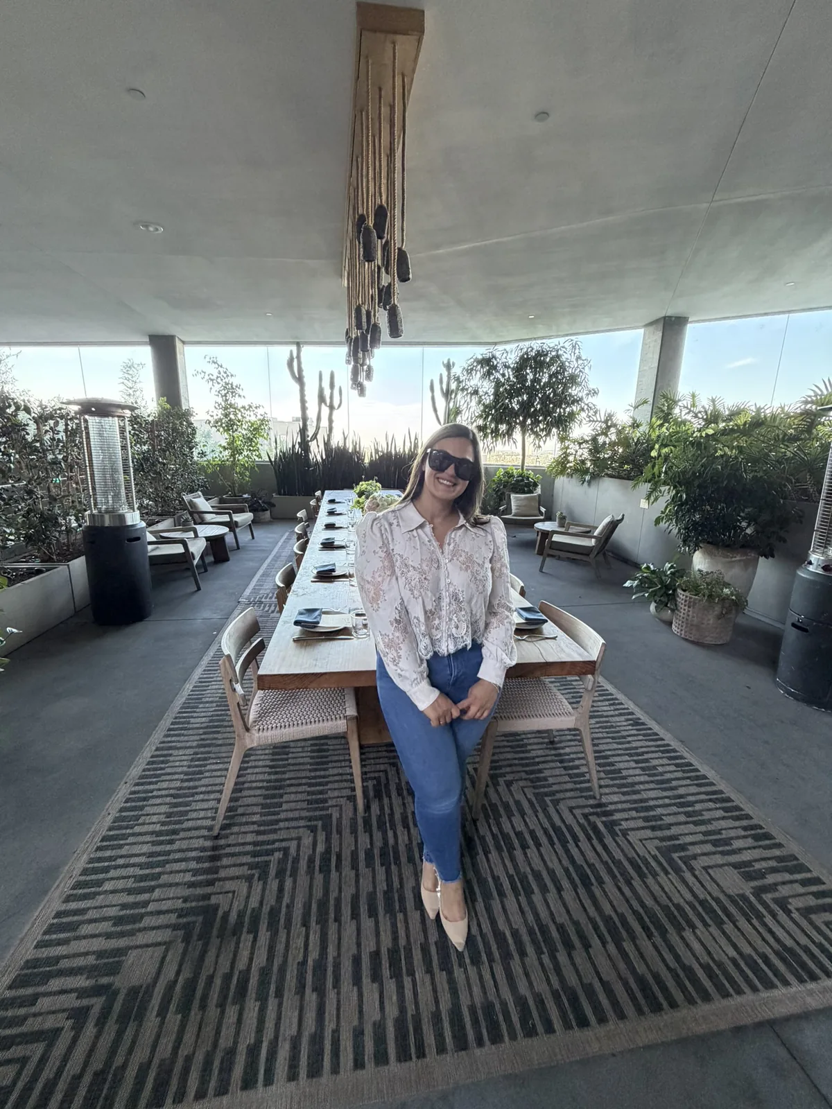 An IGNITE 2026 guest seated at the head of the rooftop long table in West Hollywood An IGNITE 2026 guest seated at the head of the rooftop long table in West Hollywood