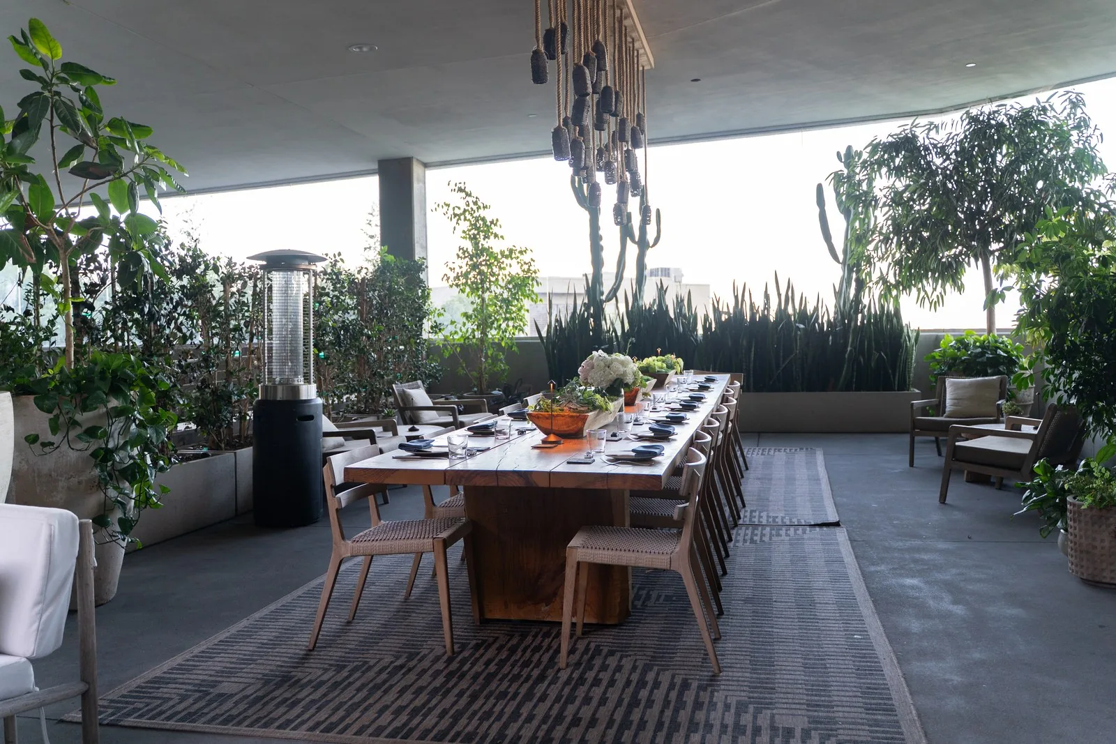 Rooftop long-table dinner set among cacti and greenery at IGNITE 2026
