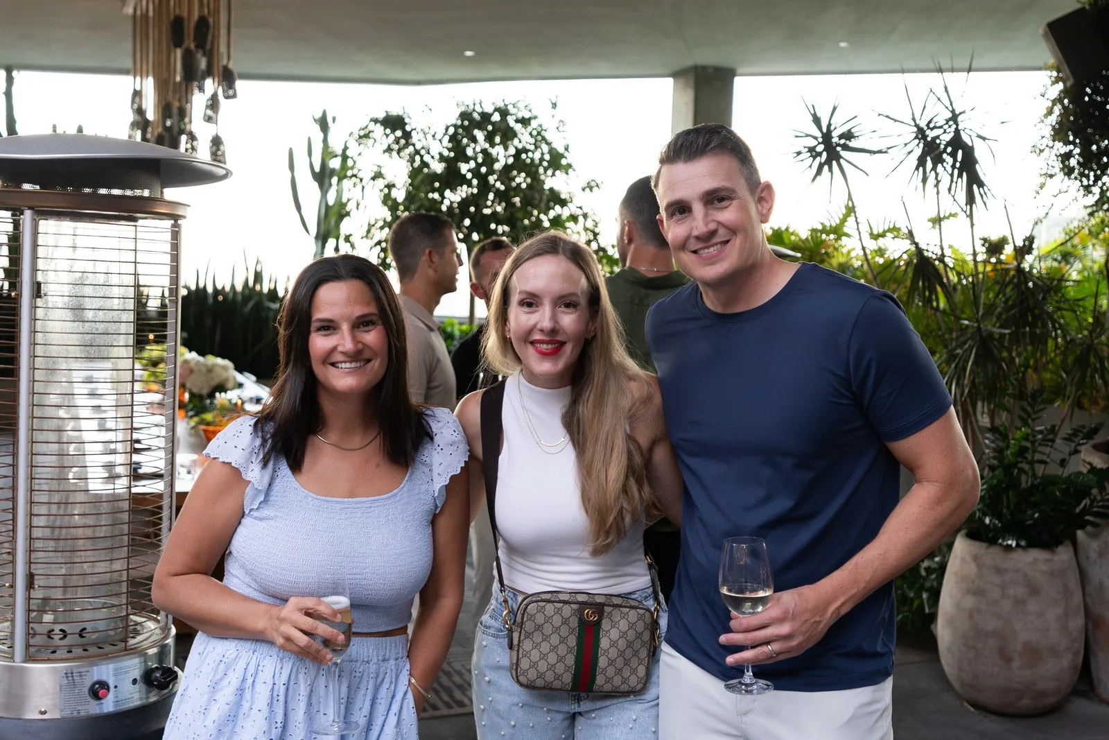 Three IGNITE 2026 guests together at the rooftop dinner Three IGNITE 2026 guests together at the rooftop dinner