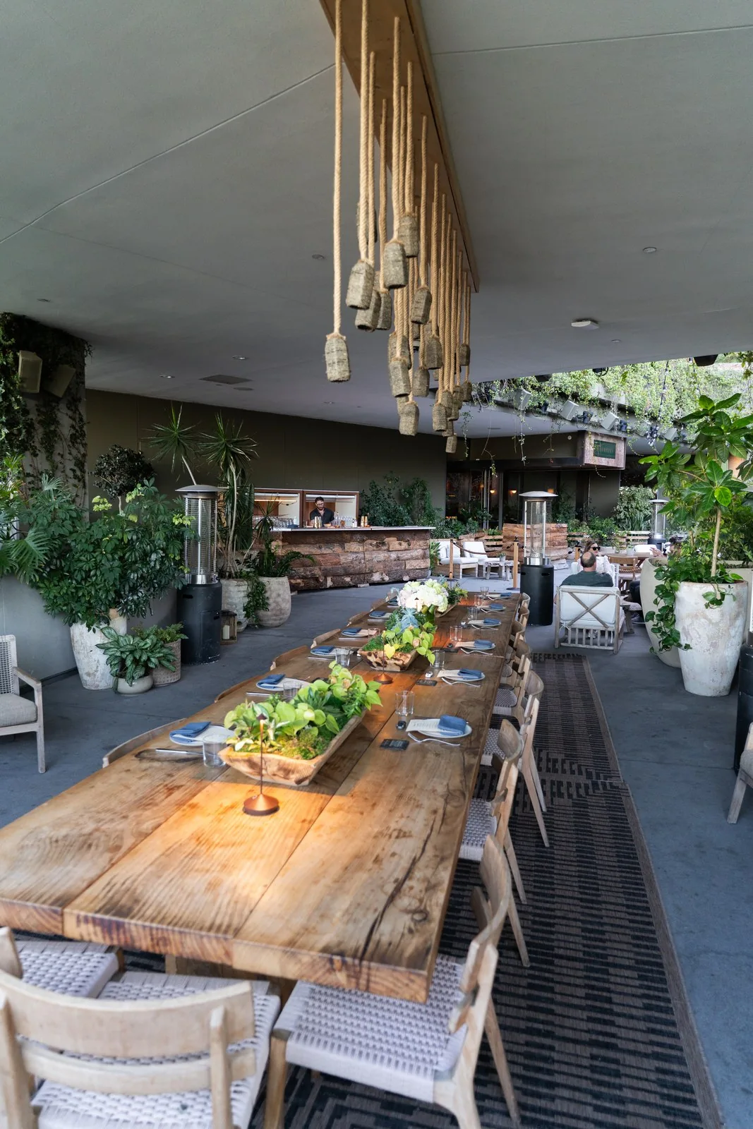 Rooftop long table set for dinner among plants at IGNITE 2026